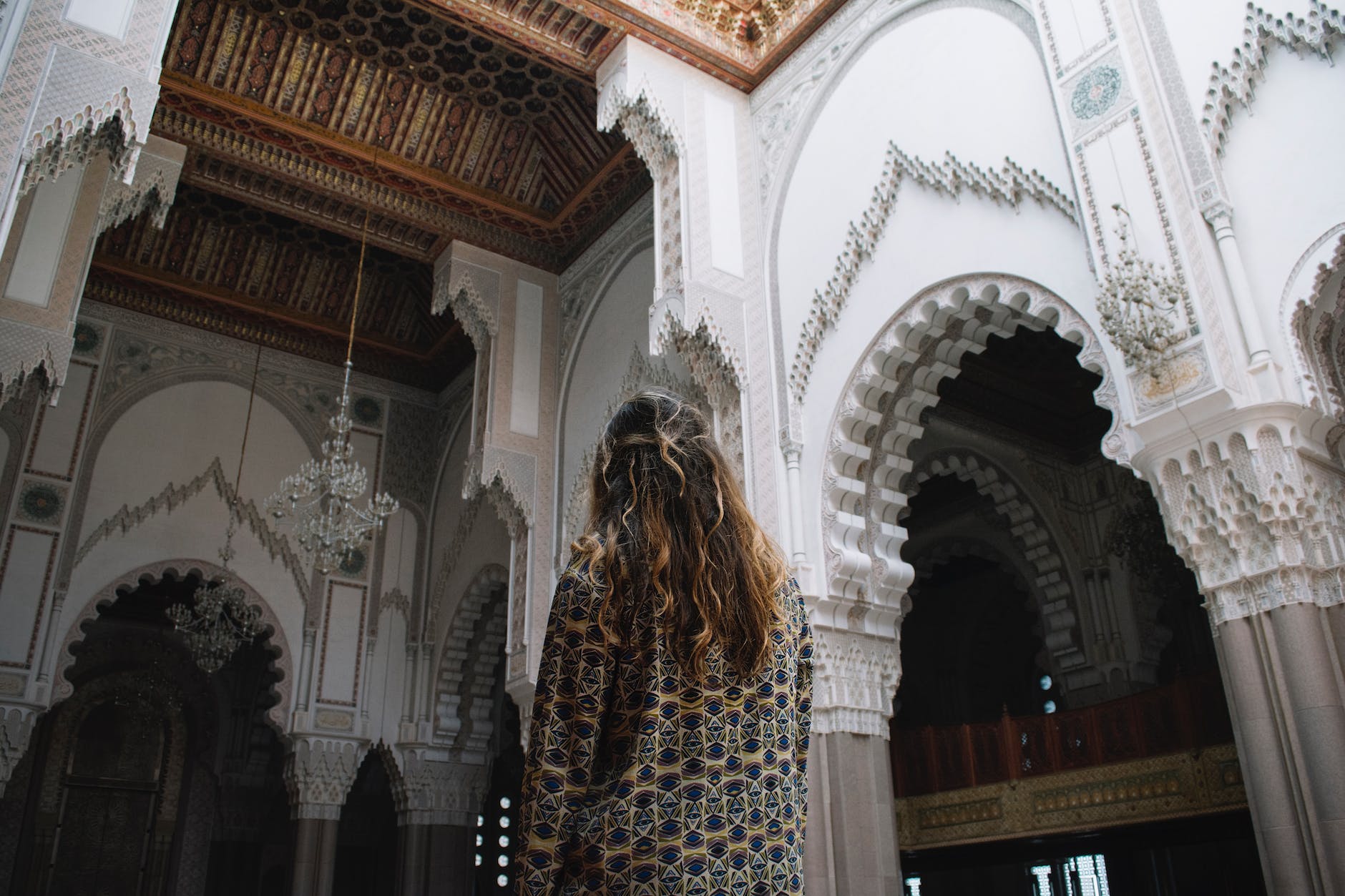 back view of a person standing inside the hassan ii mosque